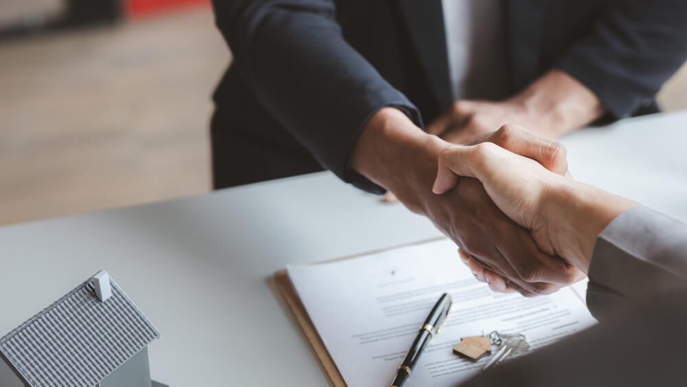 salesperson housing estate project customer shake hands after successfully signing contract concept selling housing estates real estate 1