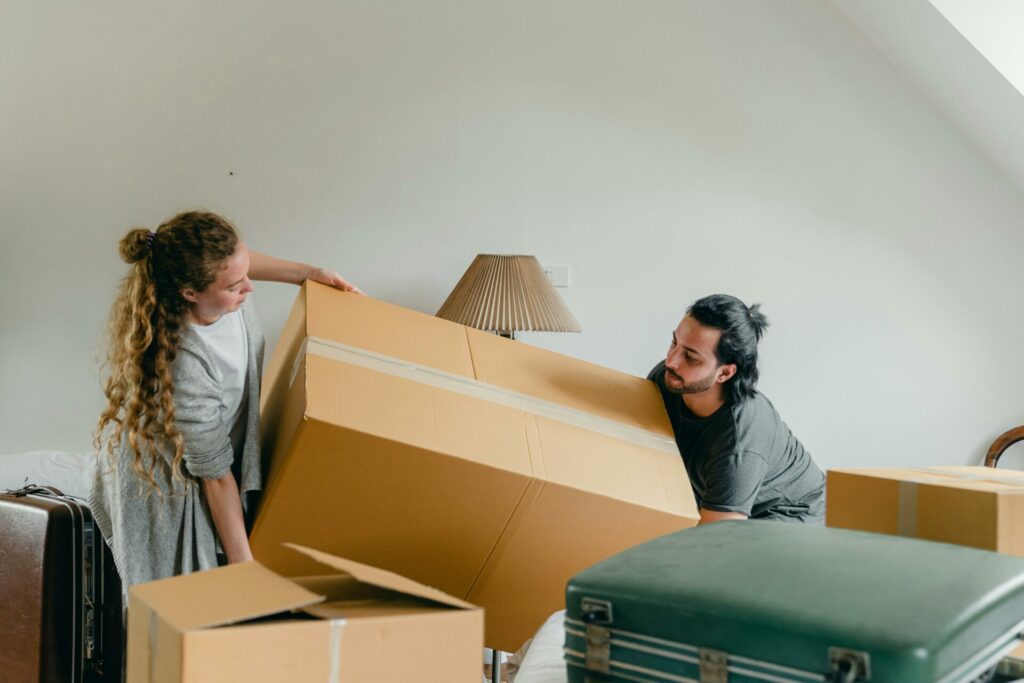 couple carrying moving boxes
